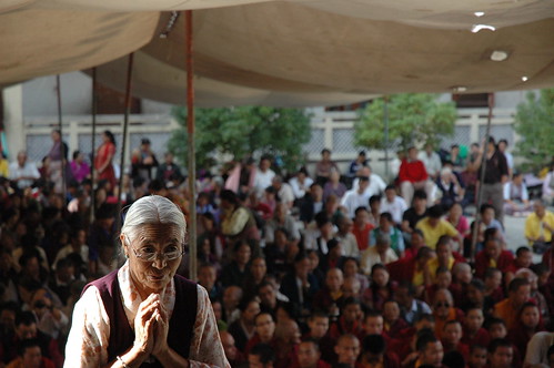 Tibetan woman prays at the front of the crowd, Sakya Lamdre, Tharlam Courtyard, Kathmandu, Nepal by Wonderlane