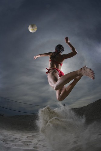A lady in bikini plays volleyball at beach by rastmansar