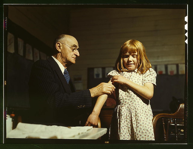 Dr. Schreiber of San Augustine giving a typhoid innoculation at a rural school, San Augustine County, Texas (LOC)