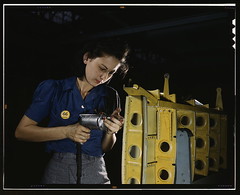Drilling horizontal stabilizers: operating a hand drill, this woman worker at Vultee-Nashville is shown working on the horizontal stabilizer for a Vultee "Vengeance" dive bomber, Tennessee. The "Vengeance" (A-31) was originally designed for the French. It