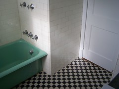 Bathtub and checkered tile floor, our house