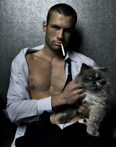 hot muscle latin hunk sexy male model holding cute cat