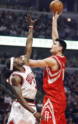 Yao Ming shoots a jump hook over Chicago' Ben Wallace in a game the Rockets won handily, 116-98.  Yao scored 18 points and grabbed 8 boards in a game where he sprained his thumb, but x-rays were negative, and Yao would come back into the after the injury to play for a few minutes with a bandage on his thumb.