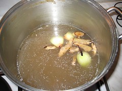 Add charred onions and ginger to stock