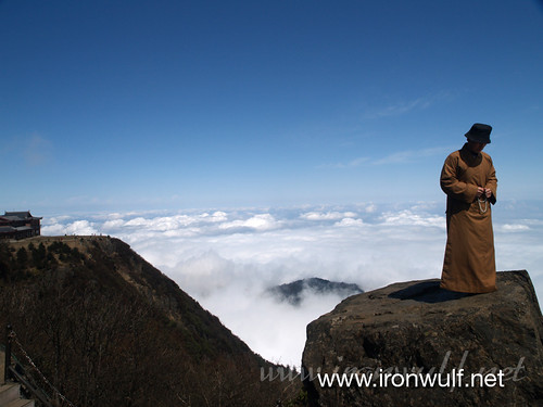 Monk in Prayer Above the Clouds
