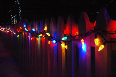 Bright lights on a white picket fence