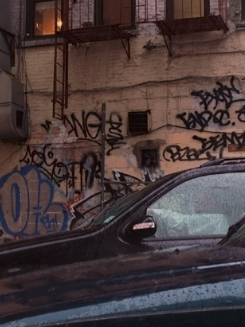 cars and graffiti and rain