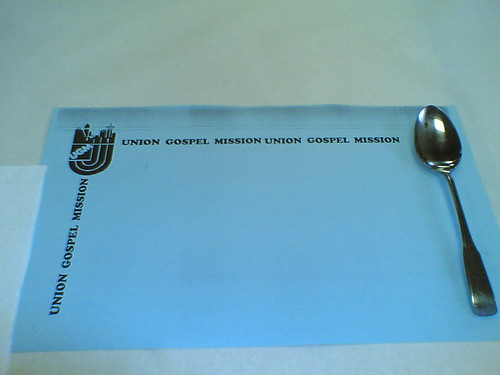 An Union Gospel Mission placemat set with a spoon