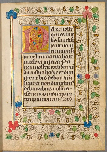 Colourful lettrine, text and incomplete border of leaves and decoration