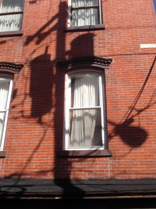 shadow of transformer on brick building