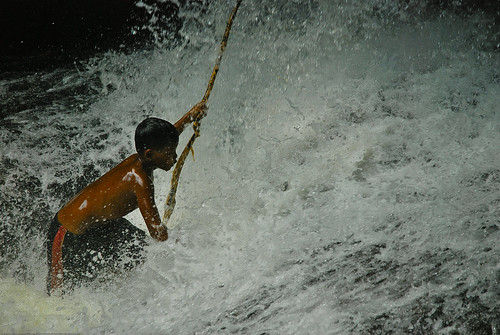 Boy playing in a waterfall at Kbal Spean, Angkor Wat