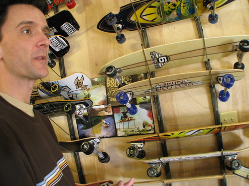 Jamey checks out skateboards at a skateboard shop in Pensacola, Florida, USA