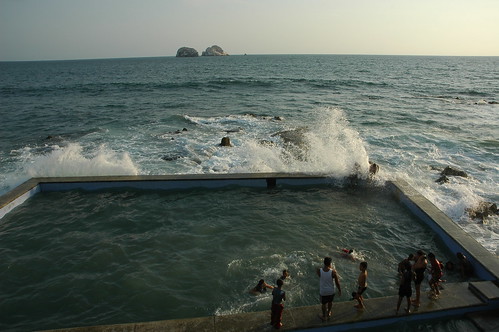 Wave splashes in! Pacific Ocean pool with kids and adults, South Mazatlan, Sinaloa, Mexico by Wonderlane