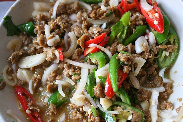 Mixture of cooked minced beef, raw onions, sliced onions, red and green chilies in egg