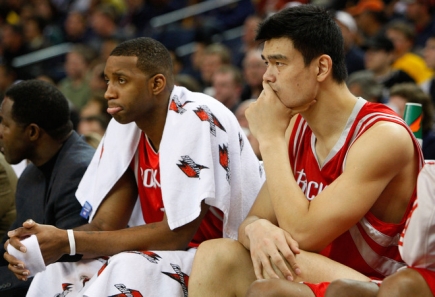 Yao Ming and Tracy McGrady sit depressed near the end of the game as the Rockets got blown out by Golden State, losing 113-94.  Both players scored 21 points collectively.