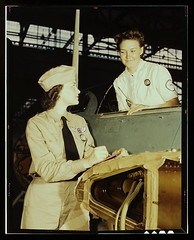 Formerly a sociology major at the University of Southern California, Mrs. Eloise J. Ellis (right) now "keeps 'em flyin'" at the Naval Air Base, Corpus Christi, Texas. She is a supervisor under civil service in the Assembly and Repair Department. It is her