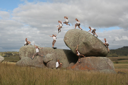 Action sport Parkour freestyle jump walking on a nature rock in a field