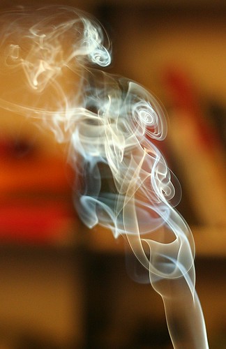 Photo of attractively curling cigarette smoke