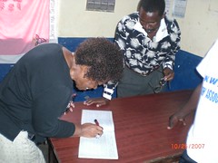 Mama E signs the guestbook in Lunga Lunga
