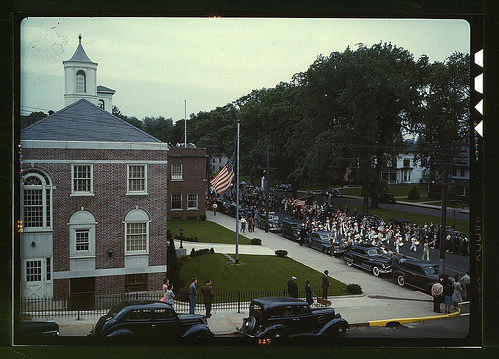 An American town and its way of life, Southington, Conn. The Memorial Day parade moving down the main street. The small number of spectators is accounted for by the fact that the town's war factories did not close. The town hall is in the left foreground.