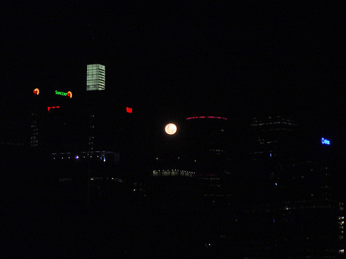 moon rising between the buildings