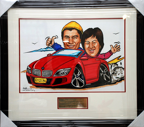 Caricatures couple BMW convertible framed with engraving