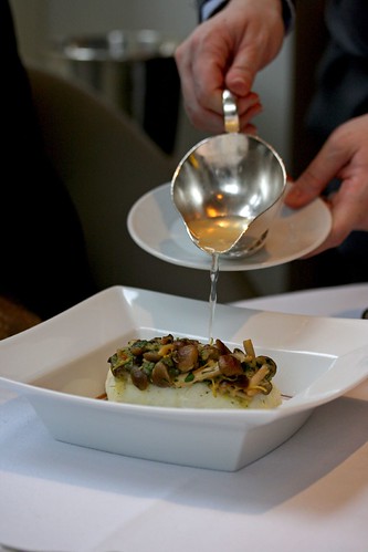 Pouring in the consommé; Halibut steamed with Honshimeji Mushrooms and Lemongrass Consommé
