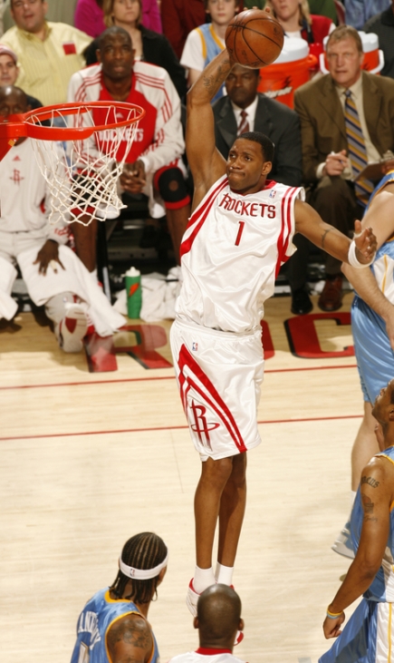 Tracy McGrady takes it strong to the hole for a jam after blowing by Denver's Eduardo Najera (not pictured) in the first quarter Sunday night.  In Yao Ming's absence, Tracy McGrady led all scorers with 22 points, 6 rebounds and 6 assists in one of his finest games of the season.  The Rockets beat the Nuggets for their 15th game in a row, which ties a franchise record.