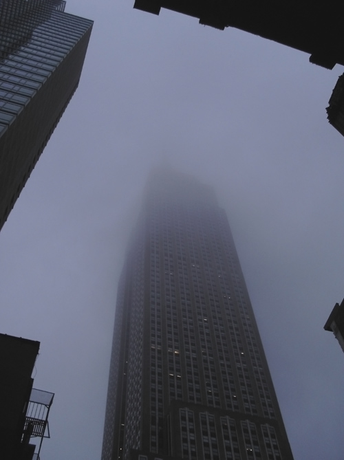 the top of the Empire State Building disappears into the clouds, NYC