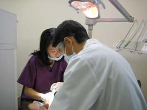 Dentist Dr. Igarashi and hygienist Kimberley Chan volunteer at the free dental clinic located in east Vancouver.