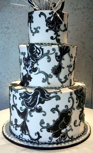 3 tier wedding cake with black white and silver layin