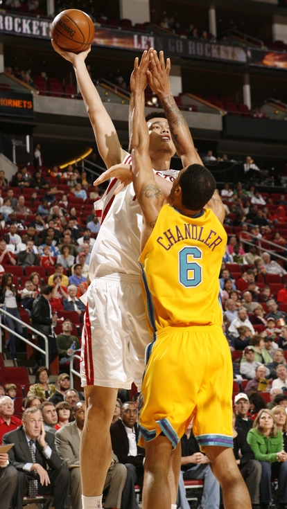 Yao Ming shoots a long beautiful jump shot over New Orleans' Tyson Chandler.  Yao was geat in scoring 30 points, snagging 16 boards, and rejecting 4 shots, but the Hornets were too much to handle in an 87-82 loss, halting Houston's 5-game winning streak.