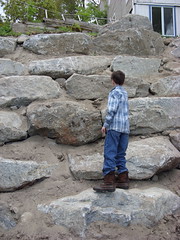 Peter scales the new stone wall.