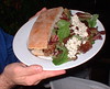 Brad's dinner - leg of lamb sandwich and a side salad with blue cheese crumbles