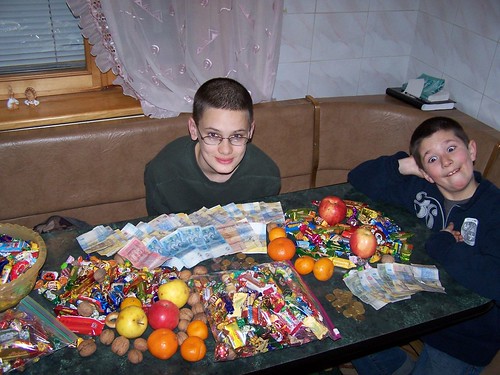 Dominic and Joshua looking over their haul of candy and money from Christmas caroling