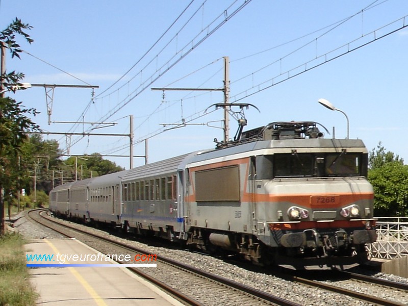 A BB 7200 SNCF electric locomotive crossing the Saint-Chamas station with a regional train to Marseille on August 2, 2006