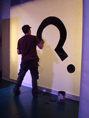 Oscar Rodriguez paints the "question mark" Unpredictable logo