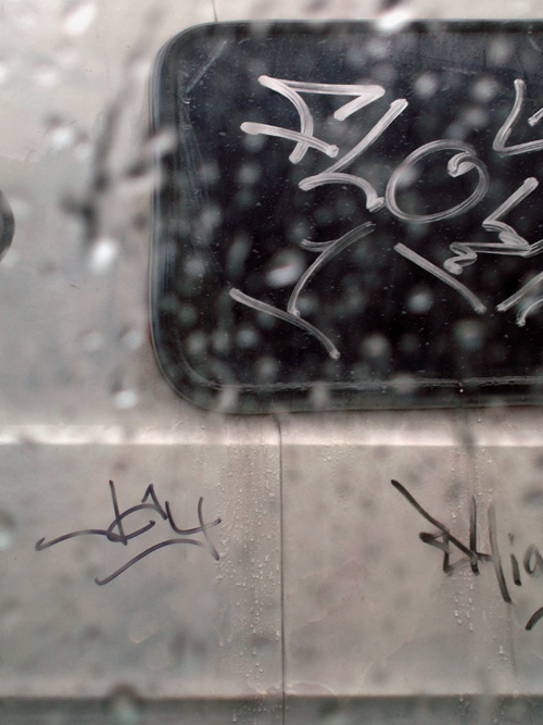 rain and graffiti through a window