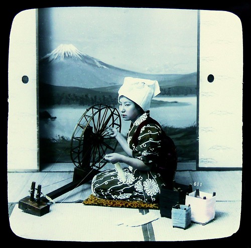 MT. FUJI FROM THE STUDIO -- Geisha in Kimono With a Spinning Wheel Against Painted Backdrop