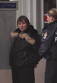 An older woman is arrested outside 411 Seniors Centre