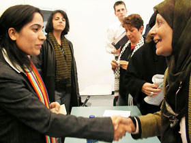 Malalai Joya (left) is shaking hands with an audience member