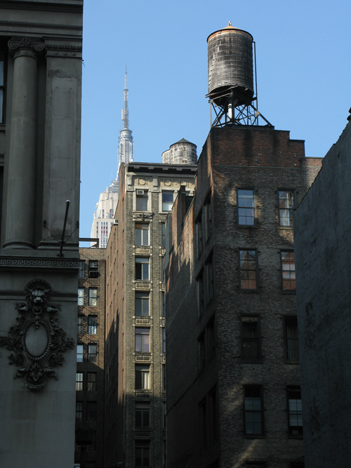several water towers and a glimpse of the Empire State Building, Manhattan, NYC