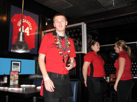 waiter at TGIF wearning Mardi Gras beads 020208