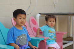 Owen and Aki sitting in little adirondack chairs