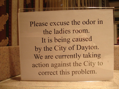 Please excuse the odor in the ladies room. It is being caused by the City of Dayton. We are currently taking action against the City to correct this problem.