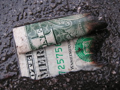 (Burned and wet dollar by gothick_matt via Flickr.com)