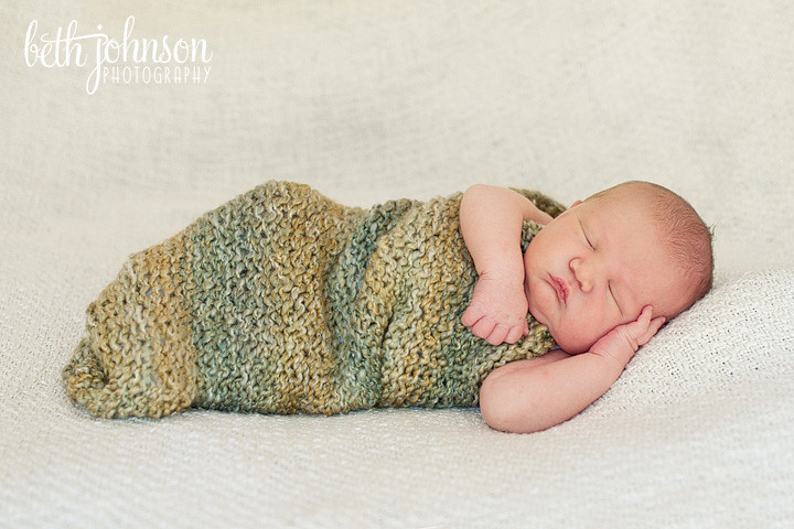 newborn baby boy in green cocoon