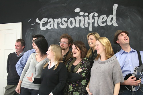 The Carsonified team standing in front of our black board