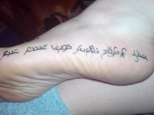 script writing tattoo on foot