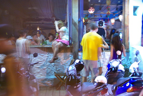 People dancing outside bars